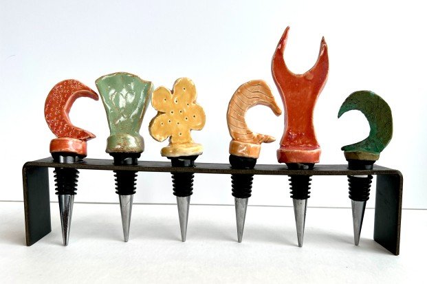 Left to right assortment of ceramic wine stoppers.